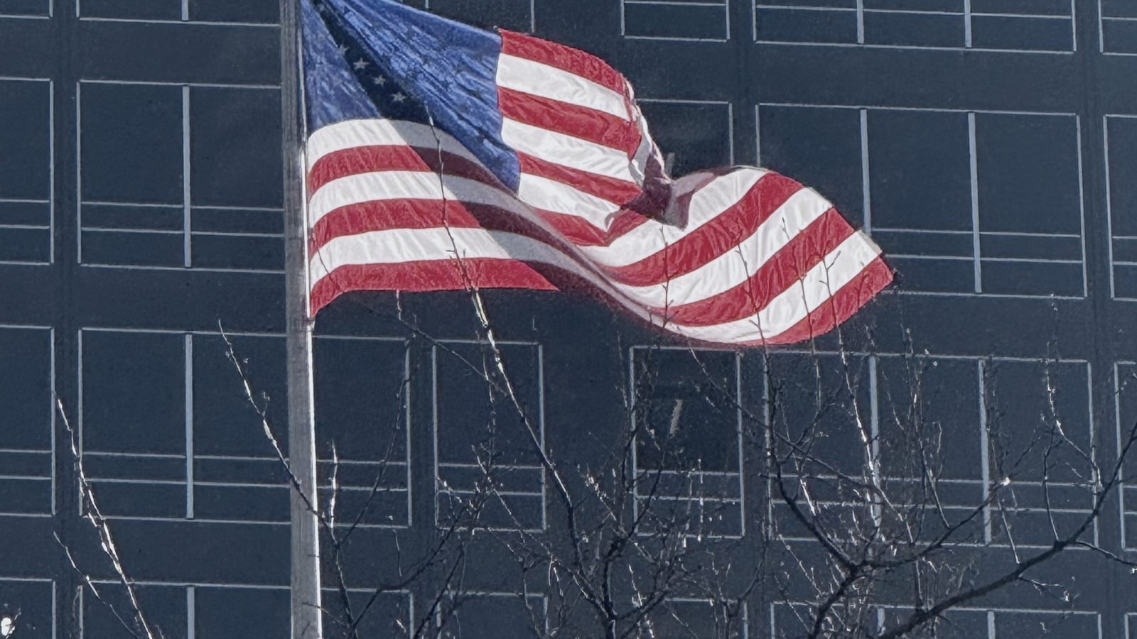 American flag in front of an office tower, New York